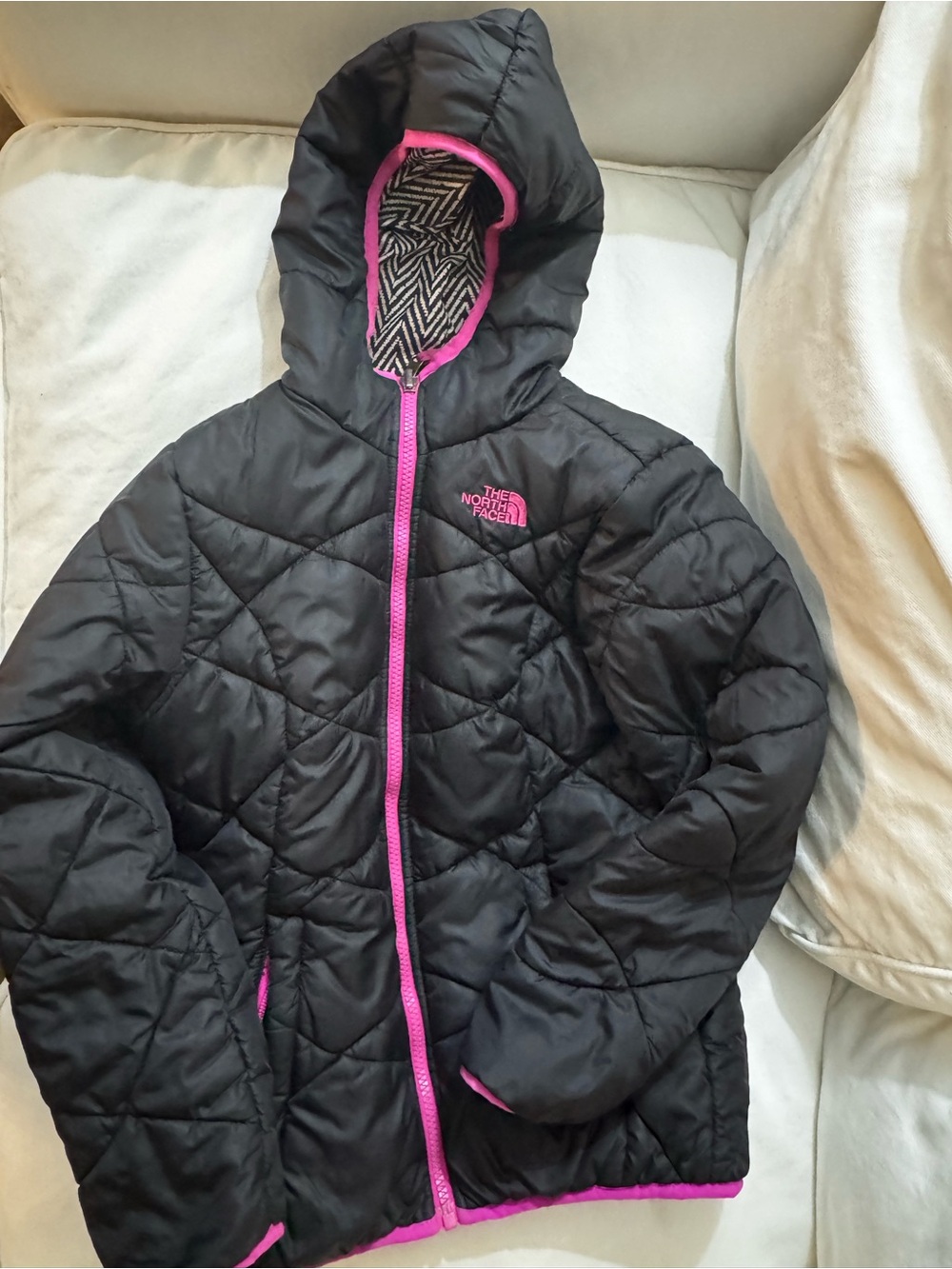 The North Face Girls Reversible Black Hooded Puffer Jacket with Pink Accents